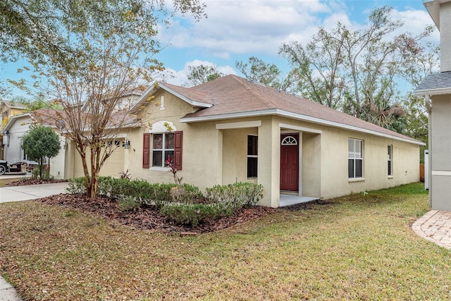 ranch-style house featuring a garage and a front lawn