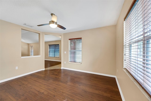 spare room featuring dark hardwood / wood-style flooring and ceiling fan