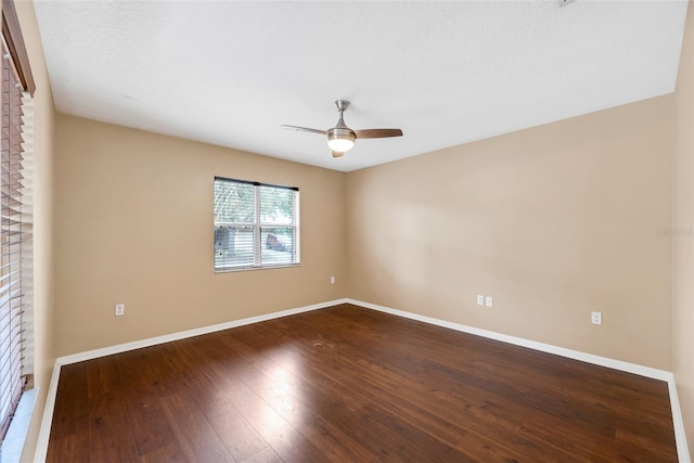 empty room with hardwood / wood-style floors and ceiling fan