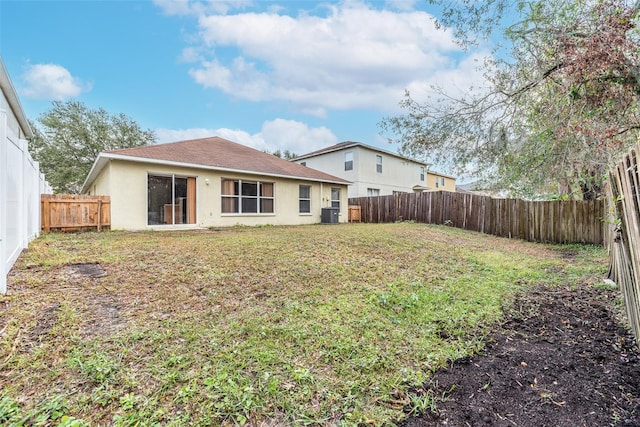 rear view of property featuring a lawn