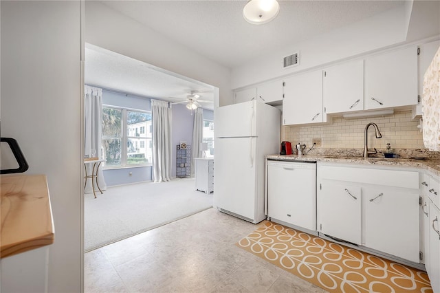 kitchen with white cabinetry, ceiling fan, light carpet, white appliances, and decorative backsplash