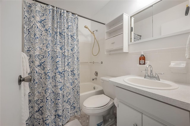 bathroom featuring vanity, toilet, tile walls, and tasteful backsplash