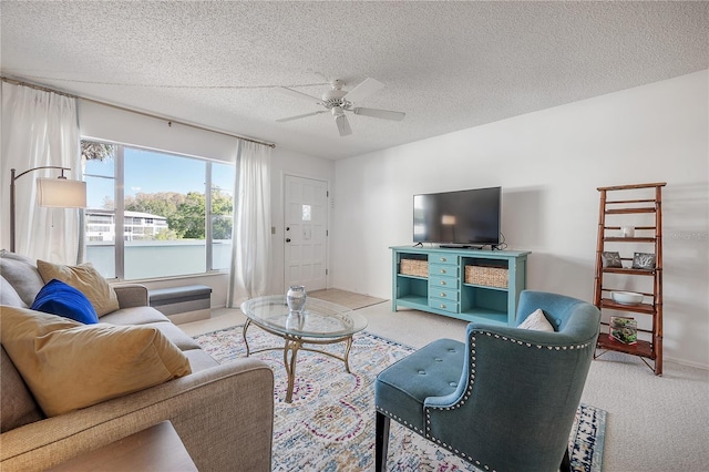 carpeted living room with a textured ceiling and ceiling fan