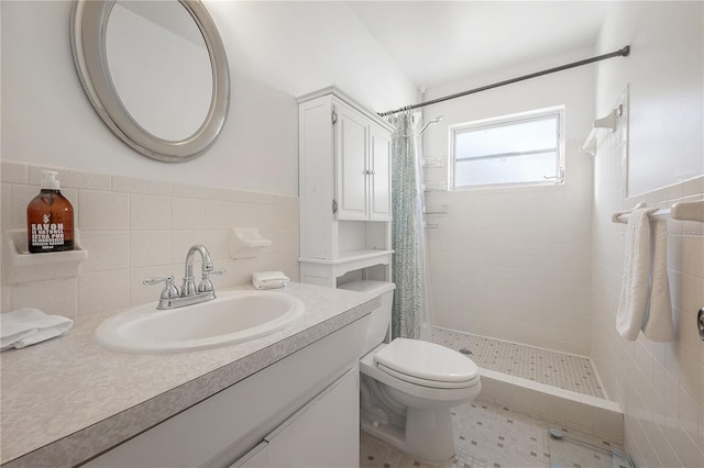 bathroom with vanity, curtained shower, toilet, and tile walls