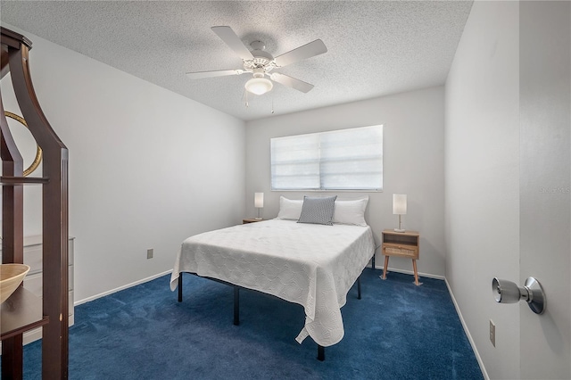 carpeted bedroom with ceiling fan and a textured ceiling