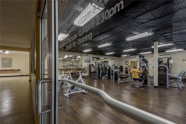 exercise room with hardwood / wood-style floors