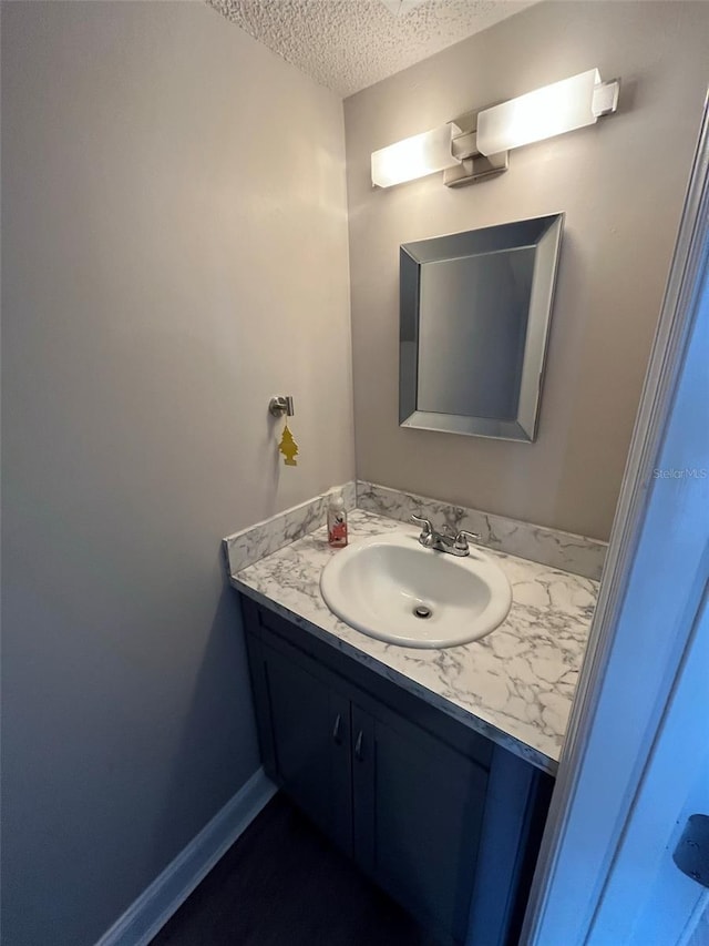 bathroom with vanity and a textured ceiling