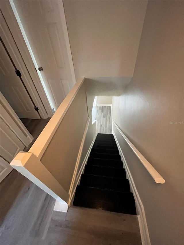 stairway with hardwood / wood-style flooring