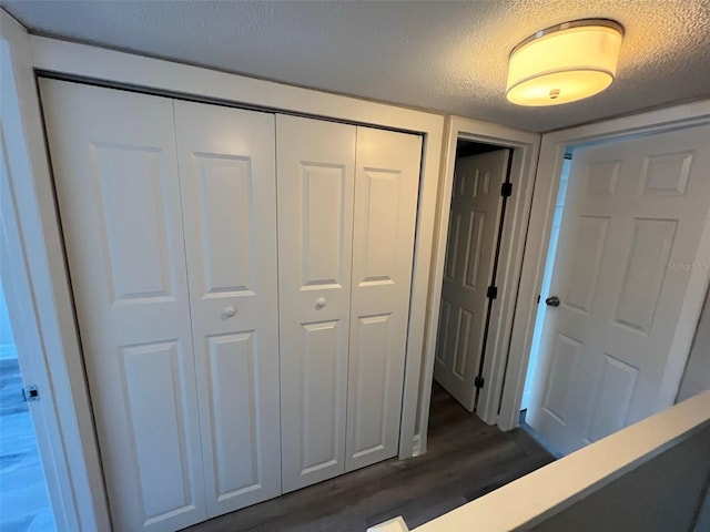 interior space with dark hardwood / wood-style flooring and a textured ceiling