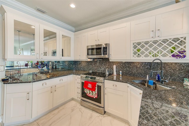 kitchen featuring white cabinetry, sink, ornamental molding, and appliances with stainless steel finishes