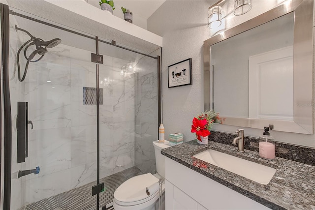 bathroom featuring vanity, an enclosed shower, and toilet