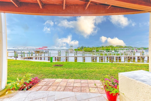 view of yard with a water view and a boat dock