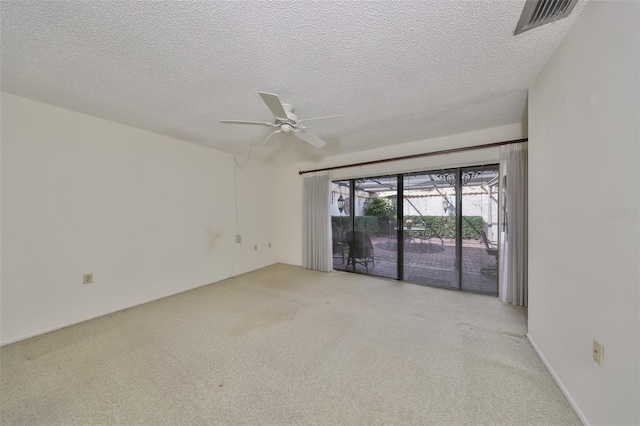 empty room featuring ceiling fan and a textured ceiling