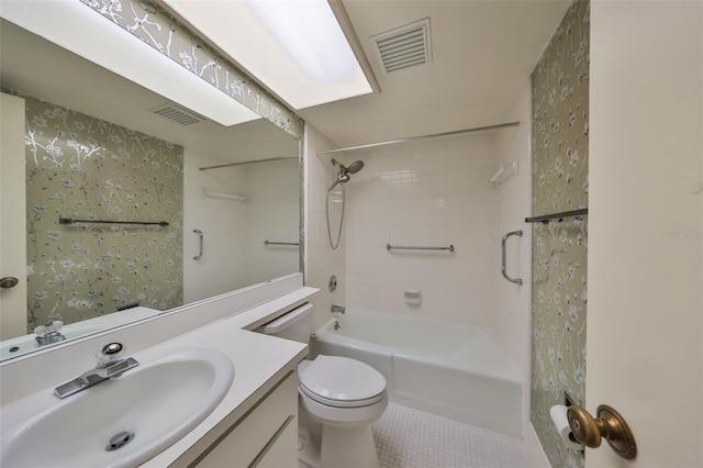 full bathroom featuring tile patterned flooring, vanity, toilet, and tiled shower / bath combo