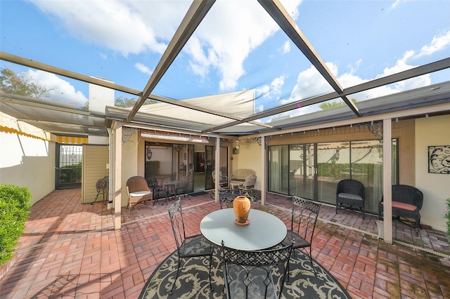 view of patio featuring glass enclosure