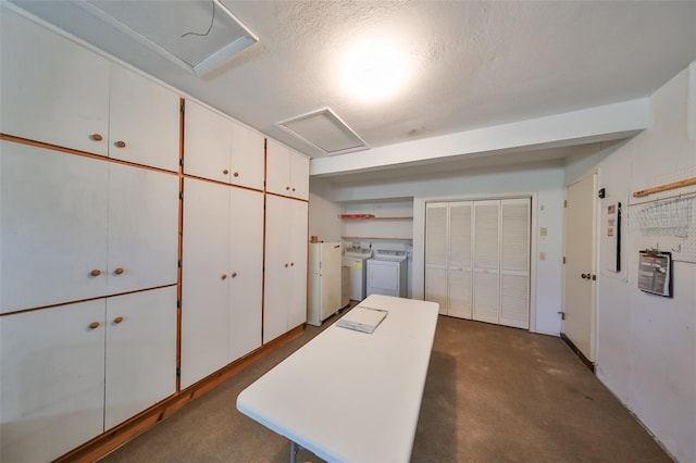 interior space with separate washer and dryer and a textured ceiling