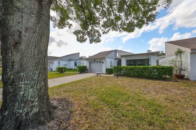 ranch-style house with a front yard and a garage