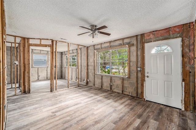 miscellaneous room featuring a textured ceiling, hardwood / wood-style flooring, and ceiling fan