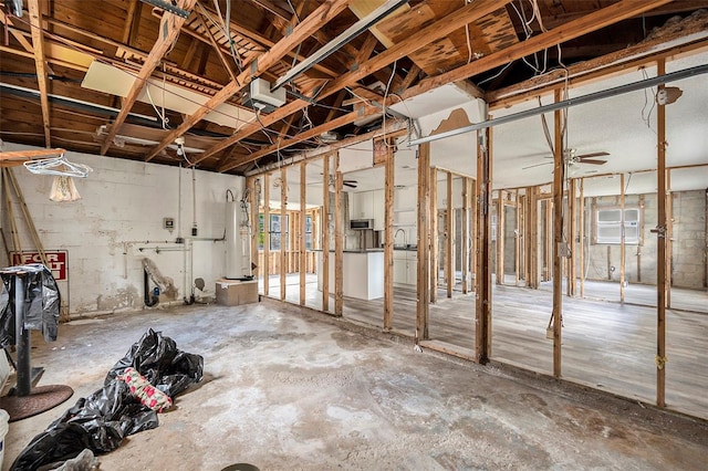 misc room with concrete flooring and water heater