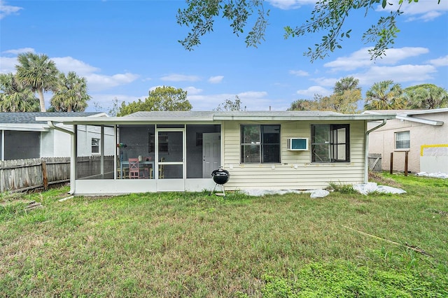 back of property featuring a sunroom and a yard