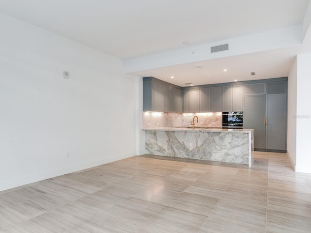 unfurnished living room featuring sink