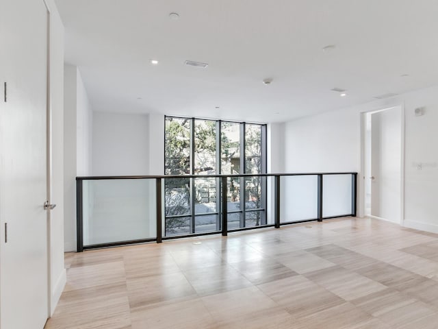 spare room featuring a wall of windows