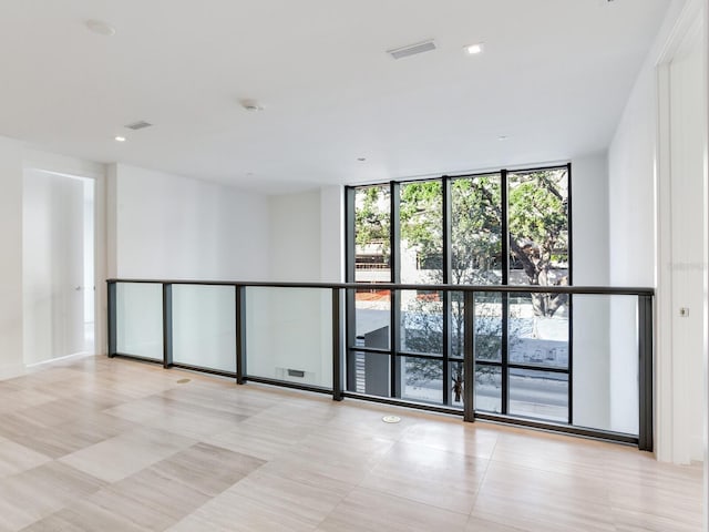 spare room featuring floor to ceiling windows