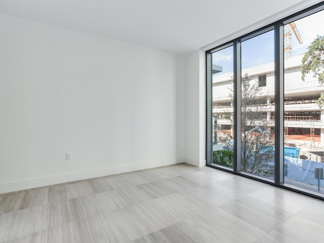 spare room featuring plenty of natural light and floor to ceiling windows