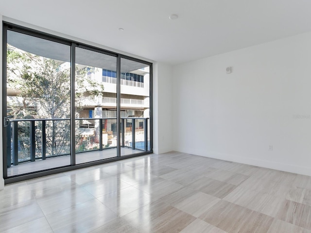 empty room featuring floor to ceiling windows and a healthy amount of sunlight