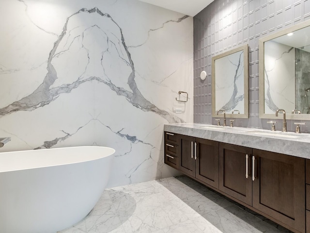 bathroom featuring a washtub, vanity, and tile walls