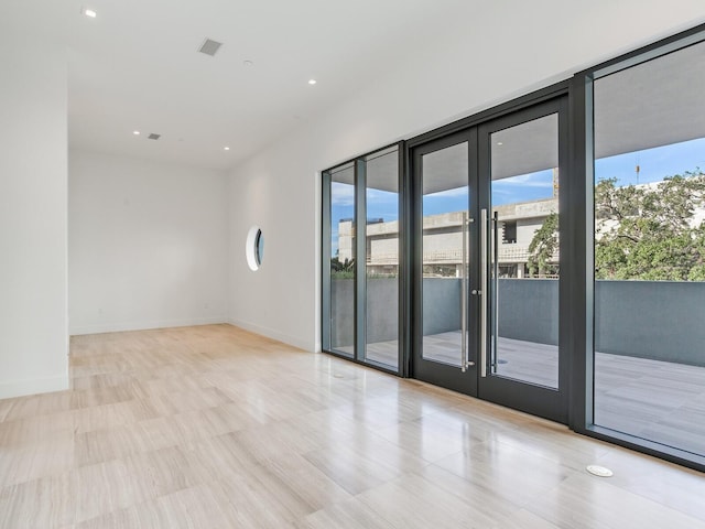 unfurnished room featuring a wall of windows