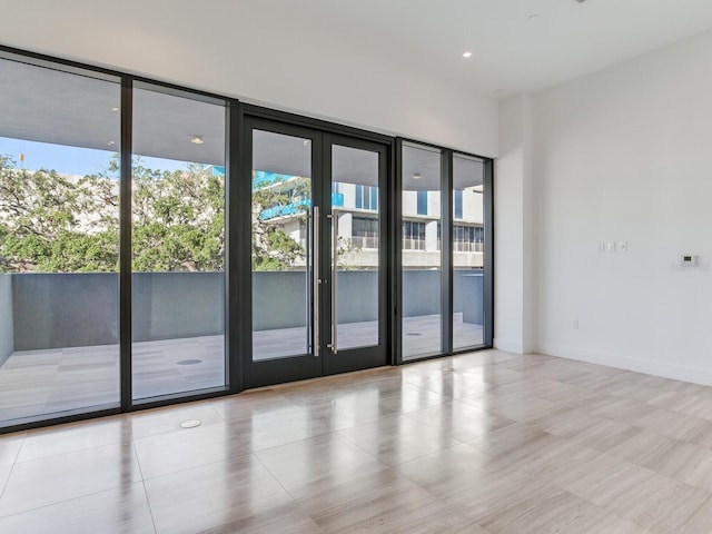 doorway featuring a wall of windows and french doors