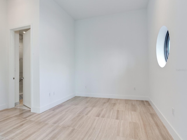 empty room with light hardwood / wood-style flooring