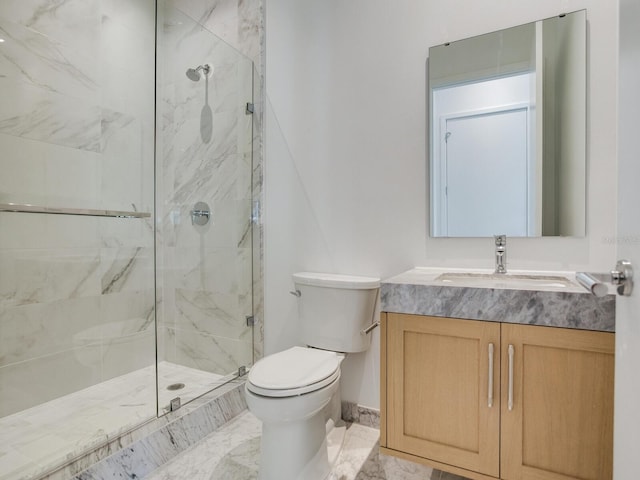 bathroom with vanity, toilet, and a shower with shower door