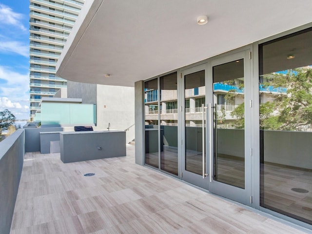 view of patio featuring a balcony and sink