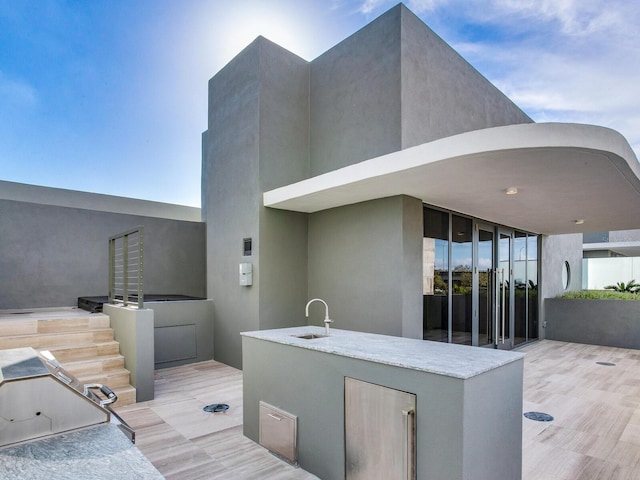 view of patio with exterior kitchen and sink