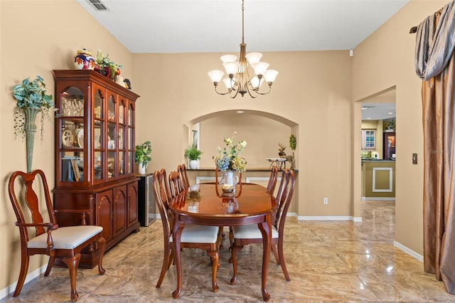 dining area with an inviting chandelier