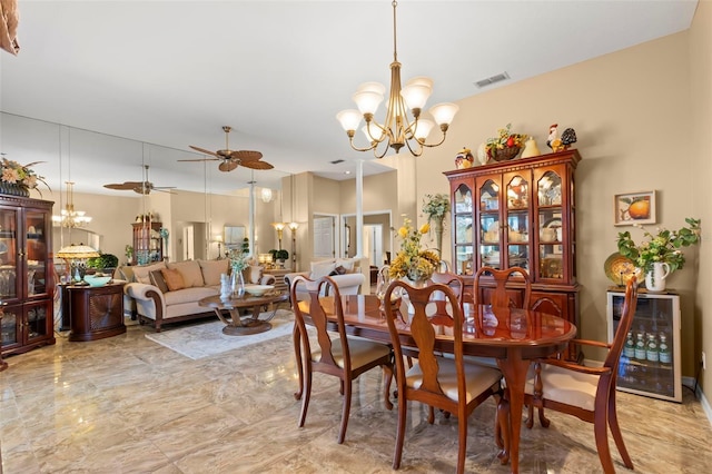 dining area with beverage cooler and ceiling fan with notable chandelier