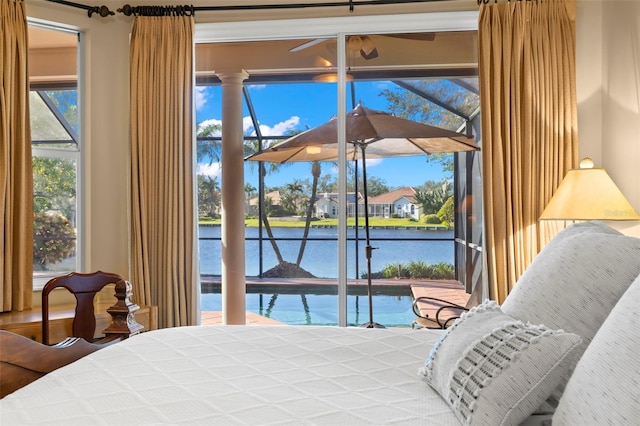 bedroom featuring access to outside and a water view