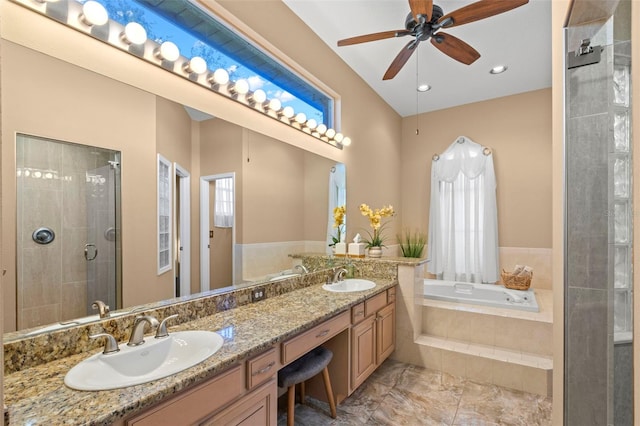 bathroom featuring ceiling fan, independent shower and bath, and vanity