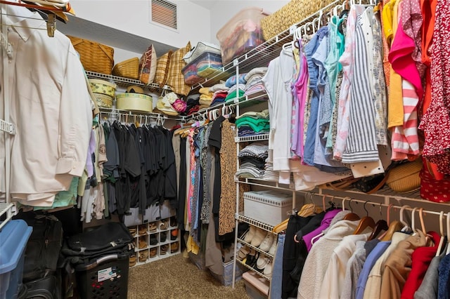 walk in closet featuring carpet flooring