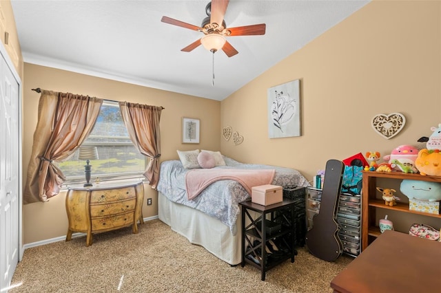 bedroom featuring ceiling fan, a closet, light colored carpet, and vaulted ceiling