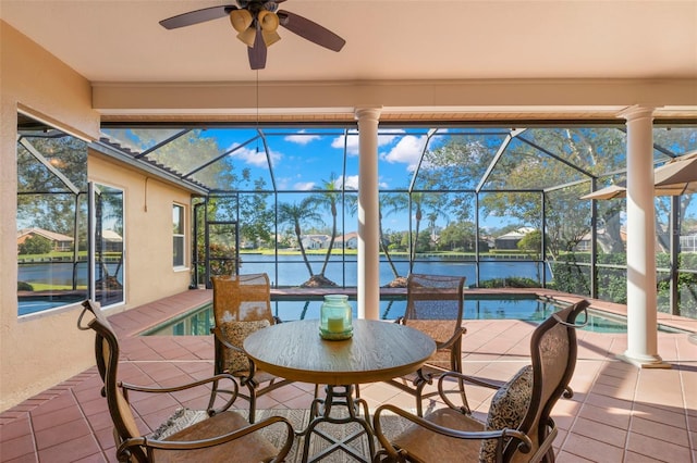 sunroom / solarium with a pool and a water view