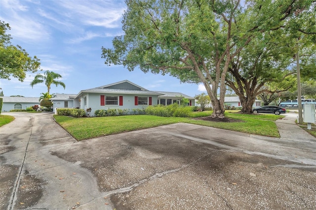 ranch-style home with a front lawn