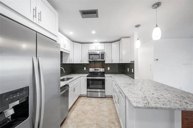 kitchen featuring stainless steel appliances, white cabinetry, hanging light fixtures, and kitchen peninsula