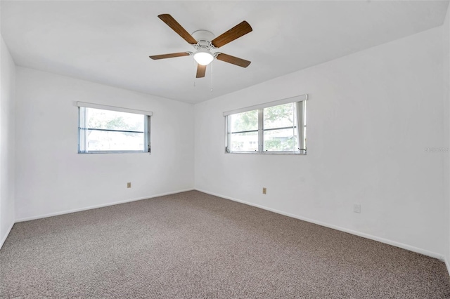 unfurnished room featuring ceiling fan, a healthy amount of sunlight, and carpet