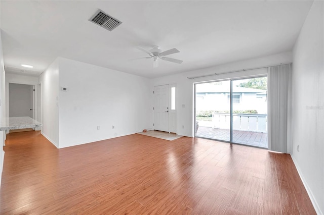 spare room featuring light hardwood / wood-style flooring and ceiling fan