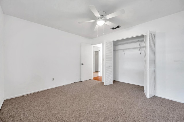 unfurnished bedroom featuring a closet, ceiling fan, and carpet flooring