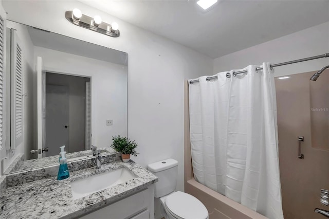 full bathroom with vanity, shower / bath combo, and toilet