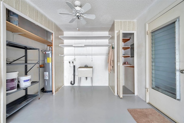 garage featuring electric water heater and ceiling fan